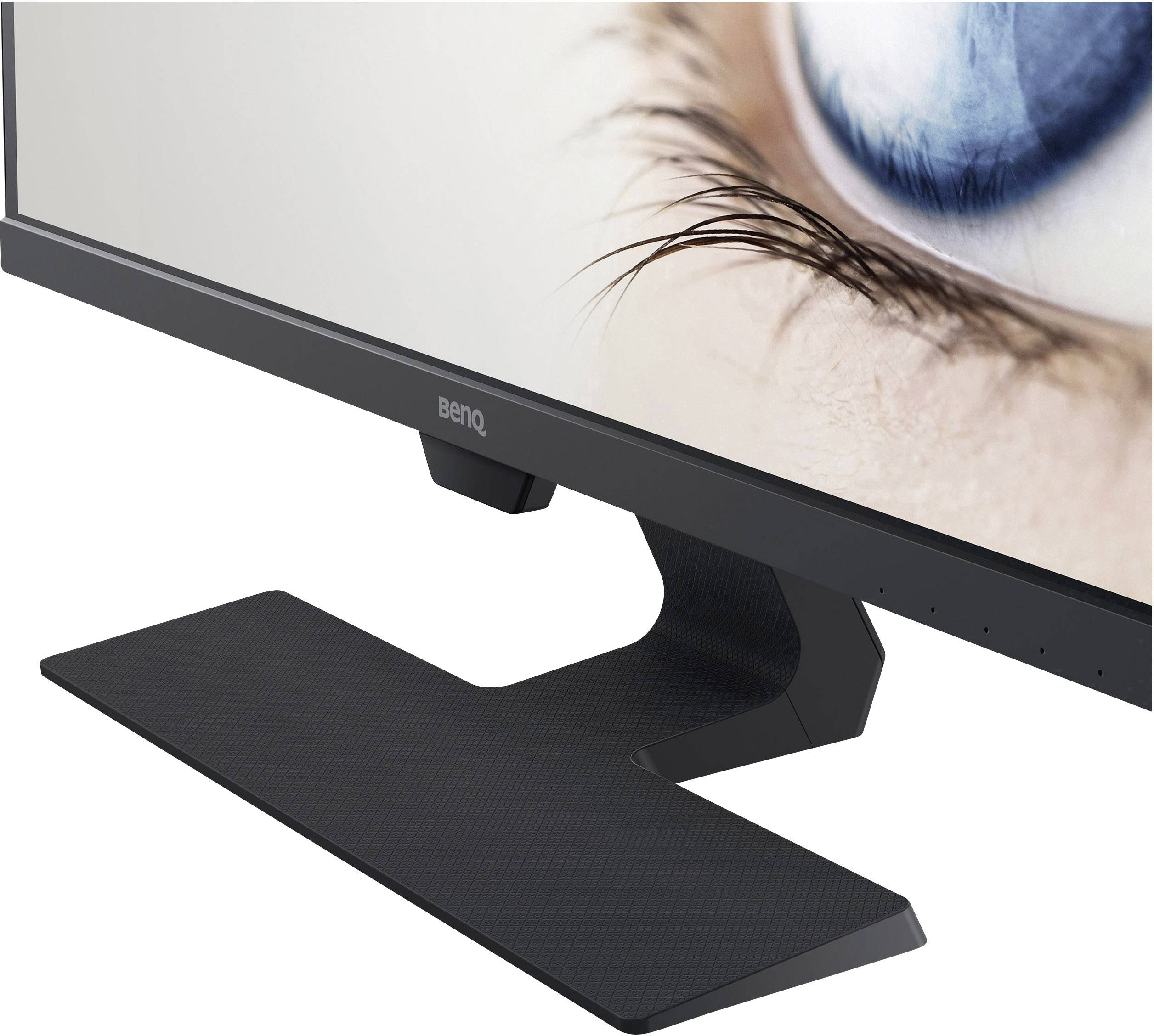 A monitor with a black stand displays an enlarged human eye on the screen.