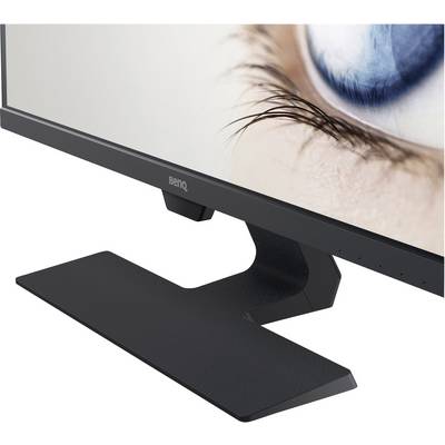 A monitor with a black stand displays an enlarged human eye on the screen.