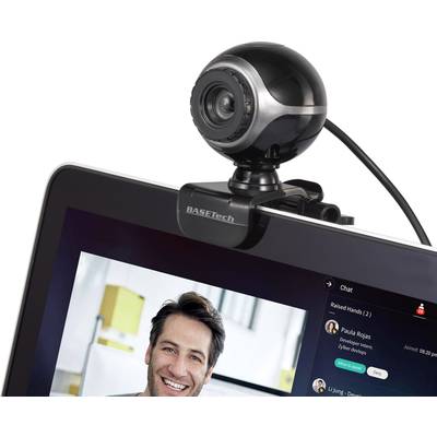 Webcam positioned on top of a monitor, displaying a video conference with a man on the screen and name labels in the chat window.