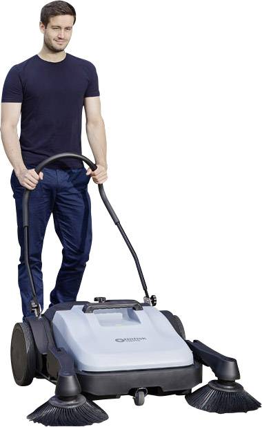A man is operating a manual street sweeper with circular brushes on a floor.