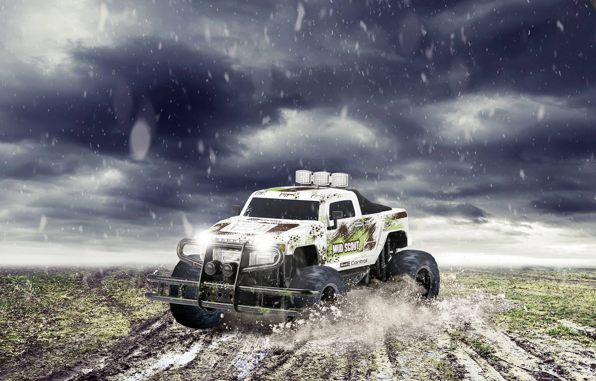 An off-road truck drives through muddy terrain beneath a dark, cloudy sky. Splashes of mud and water emphasise the drama.