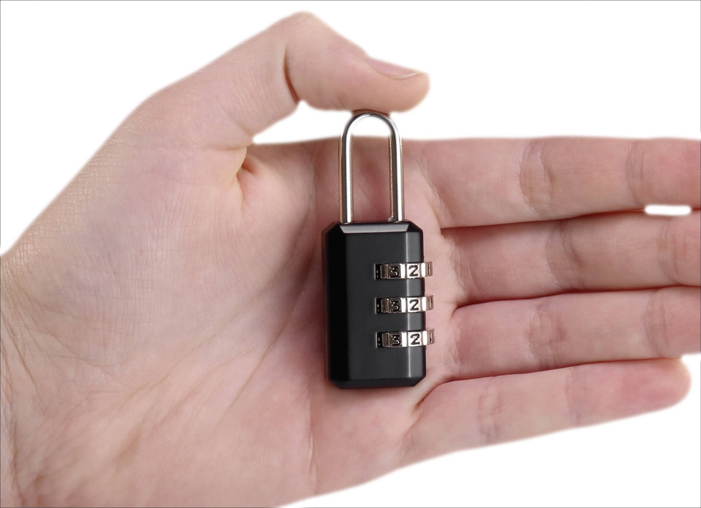 A hand is holding a small black combination lock with three numerical dials.