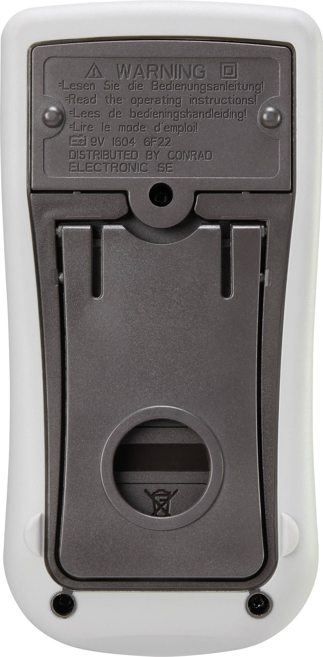 Back of an electronic device. Shows a battery compartment and warning notices in multiple languages, including 'Please read the instruction manual'.