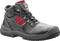 Robust black safety shoe with red inner lining and red detail on the side, lace-up fastening and non-slip sole.