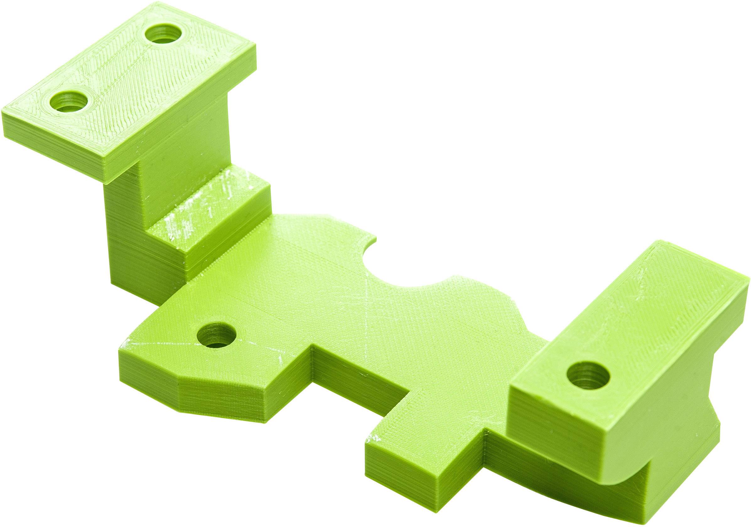 Green, rectangular plastic component with four screw holes; serves as a mounting bracket or fastening element.