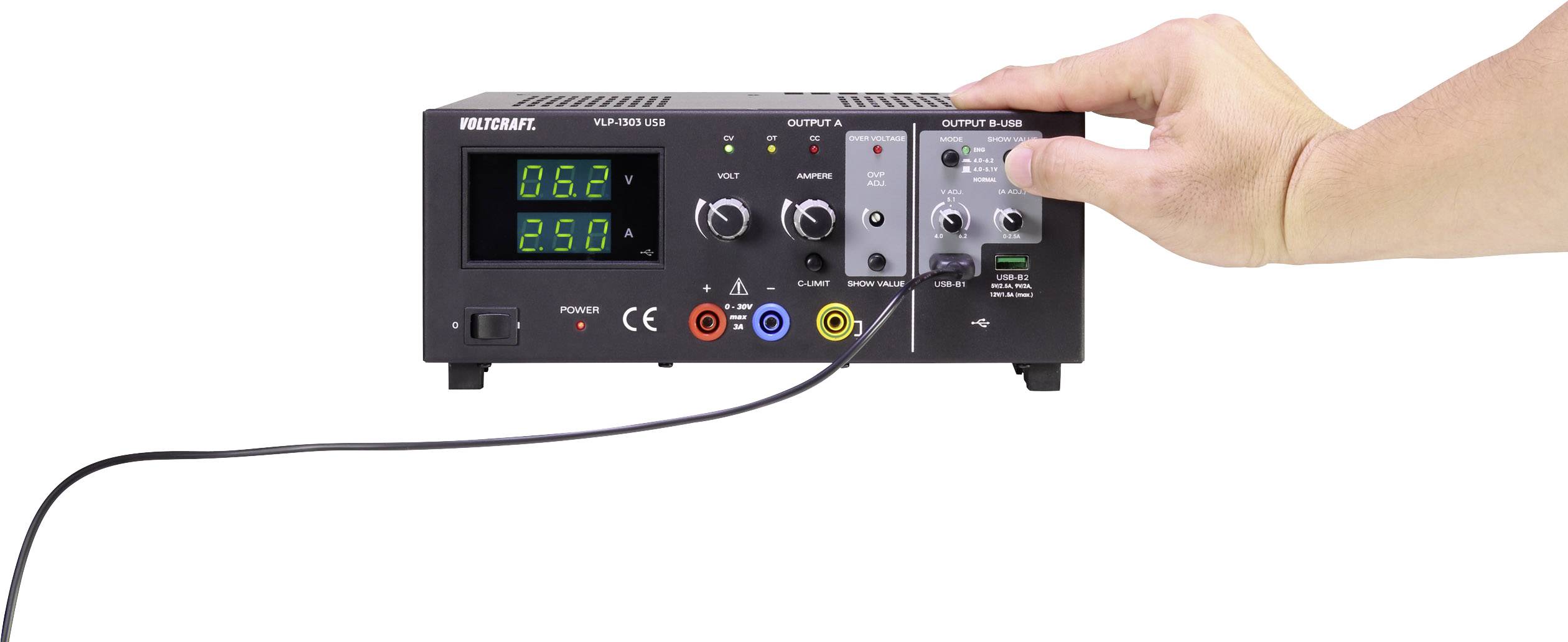 A hand adjusts a rotary knob on a laboratory power supply with a digital display. The values on the screen show '0.82' and '2.50'.