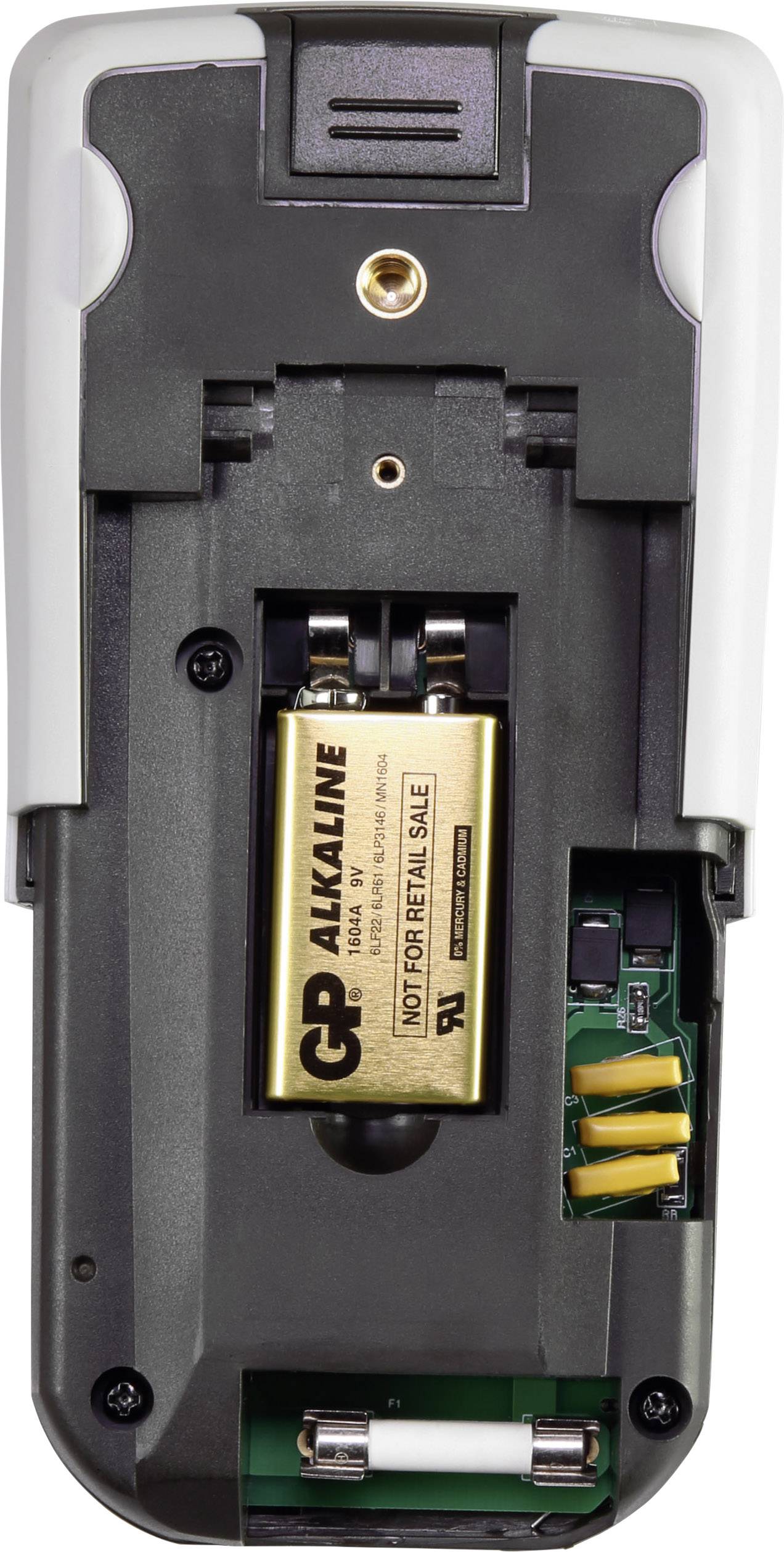 Back of a device with the battery compartment open. A yellow alkaline battery is inserted. Electronic components visible.