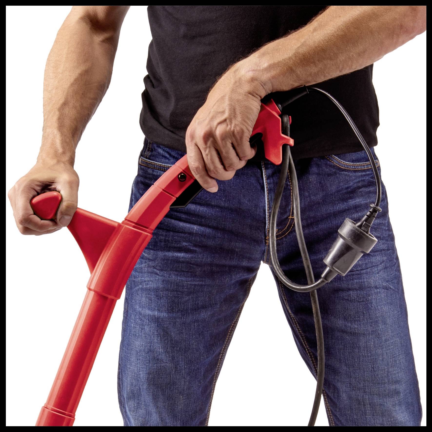 A person is holding a red vacuum cleaner in their hands. The vacuum cleaner has a black cable.