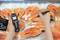 A person is measuring the temperature of fresh salmon with a digital thermometer on ice.