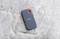 External SSD by SanDisk on a stone surface, compact and portable, ideal for mobile data storage.