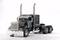 Black American articulated lorry without a trailer, featuring large chrome exhaust pipes, stands against a white background.