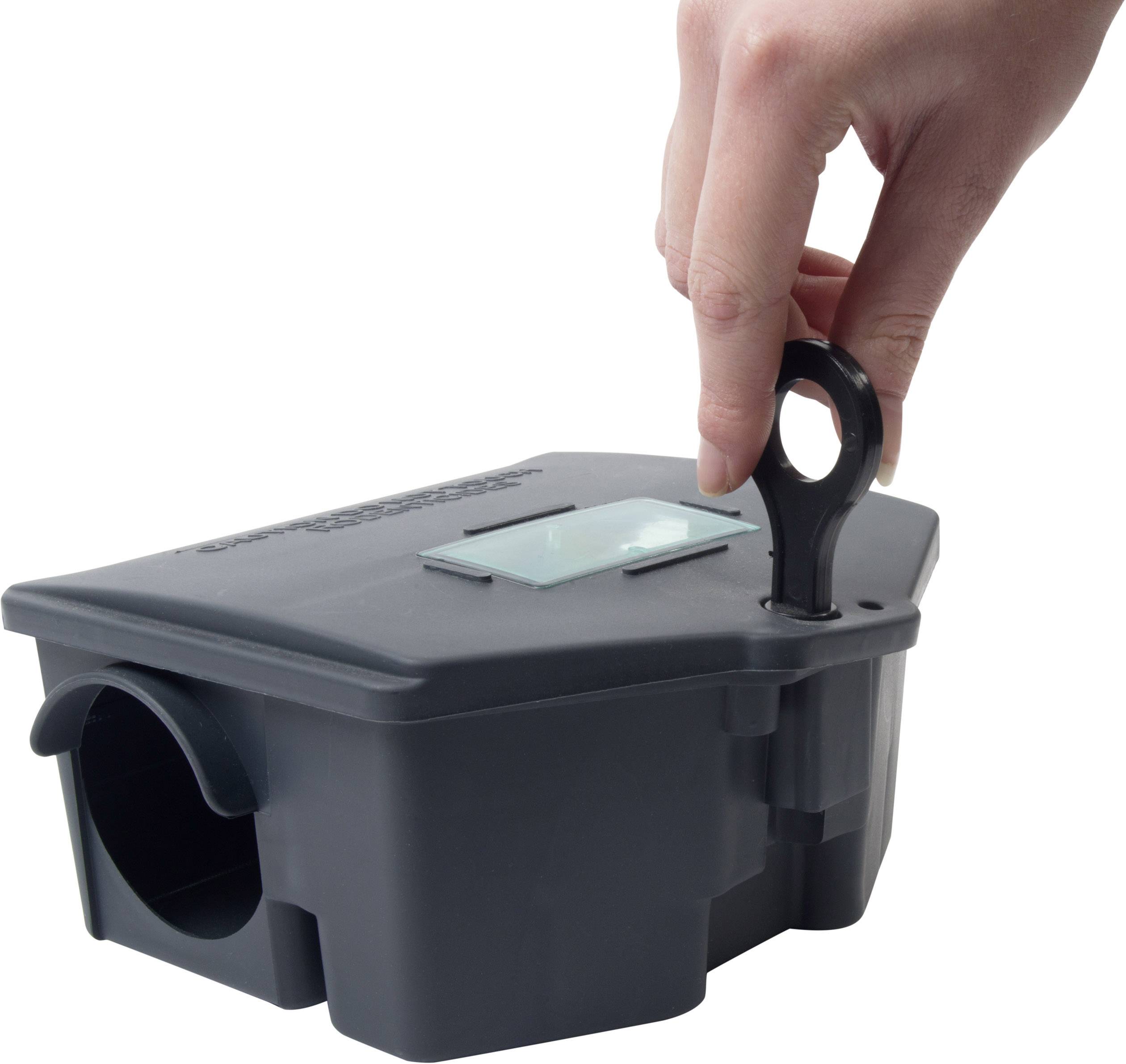 A hand opens the lid of a grey box with a key, possibly a mousetrap or a security container.