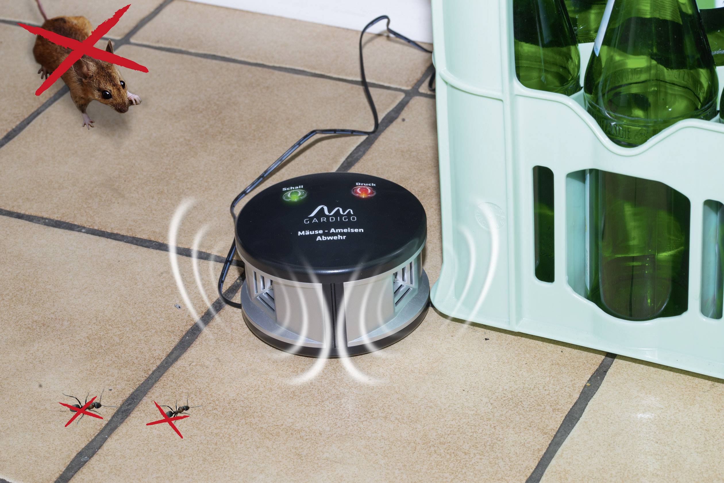 A mouse deterrent device stands next to a beer crate. Sound waves are shown to repel mice and insects.