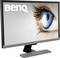 A BenQ monitor on a table, displaying a large blue eye on the screen.