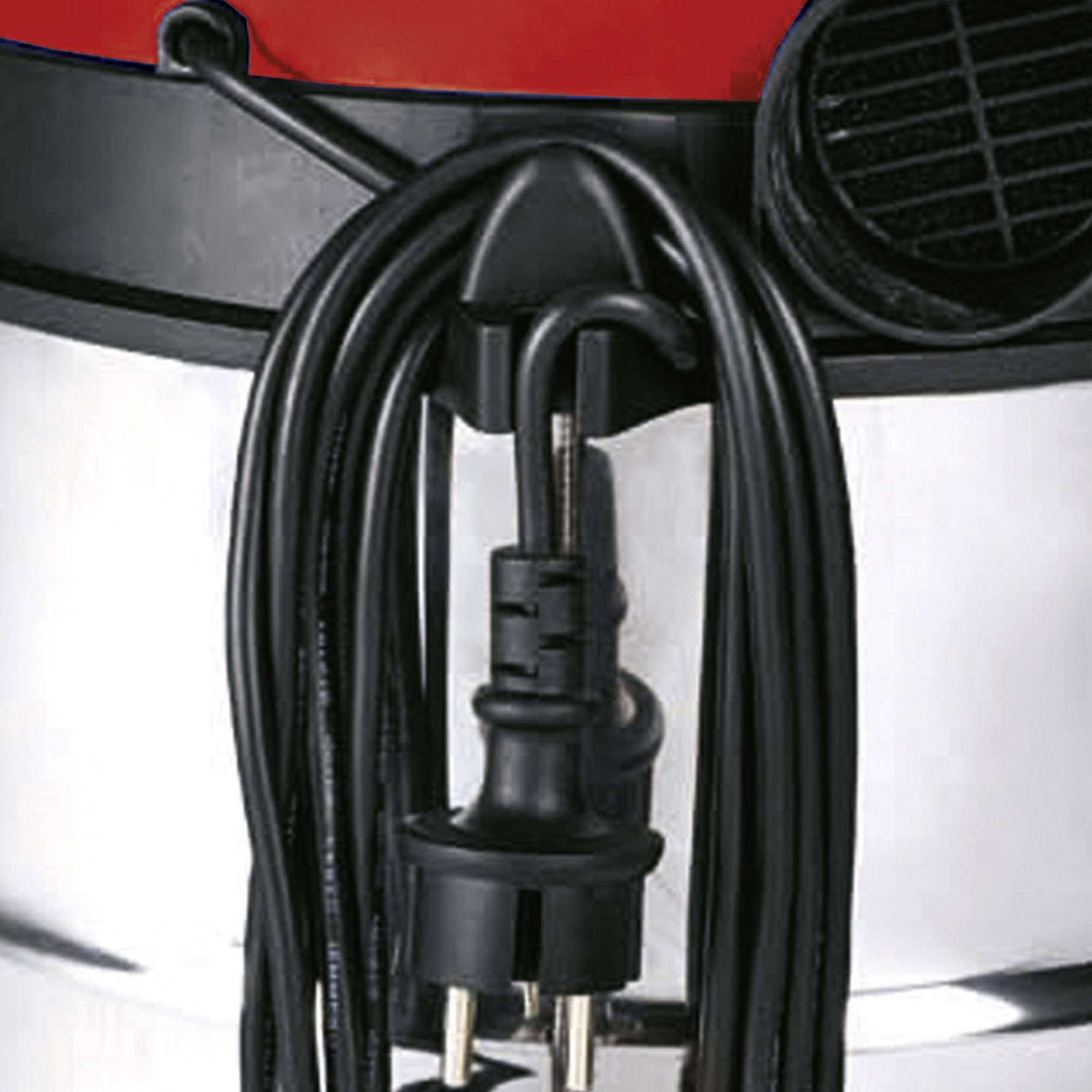 Close-up of a vacuum cleaner with a red, black, and silver casing. Power cable neatly coiled around a stand.