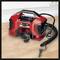 'Einhell PRESSITO' air compressor in red, with a black handle, sitting on a wooden table. Accessories such as hose and adapters lying beside it.