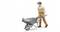 A miniature figurine of a construction worker in a hard hat and overalls is pushing a wheelbarrow filled with tools.