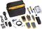 A network testing kit with a black case, multiple measuring devices, cables, batteries, and manuals for professional network diagnostics.
