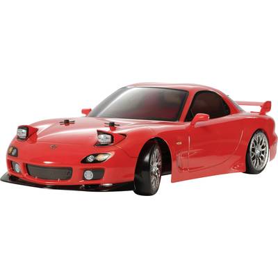 Red toy car at 1:10 scale, based on a sports car model, with an open driver's window and visible details.