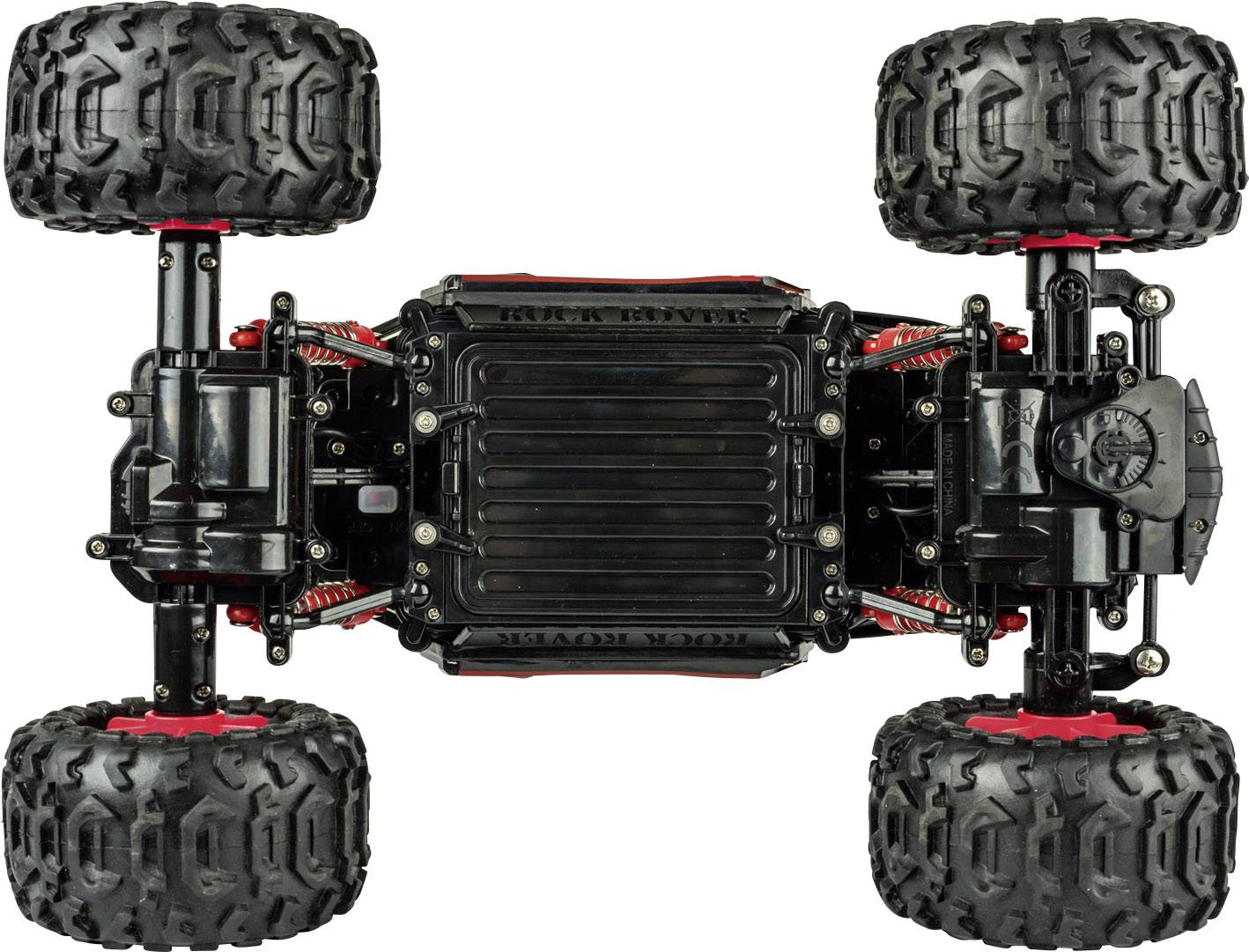Remote-controlled car viewed from underneath, showing suspension and robust tyres.