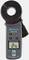 Digital earthing clamp meter with display reading '12.75Ω', brand logo, various settings and measurement buttons.