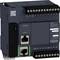 Schneider Electric M221 programmable controller with multiple interfaces including serial and Ethernet ports, displaying inputs/outputs.