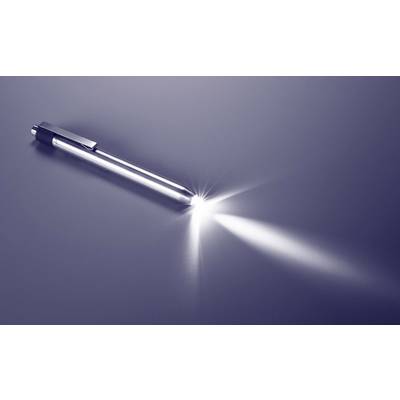 A ballpoint pen lies at an angle on a smooth, reflective surface. A beam of light illuminates its tip.