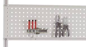 A perforated metal panel with tools: four screwdrivers with red handles and a pair of pliers with a black handle.