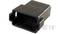 Black, rectangular plastic plug with multiple holes for connecting electronic devices. 'TE' marking visible.