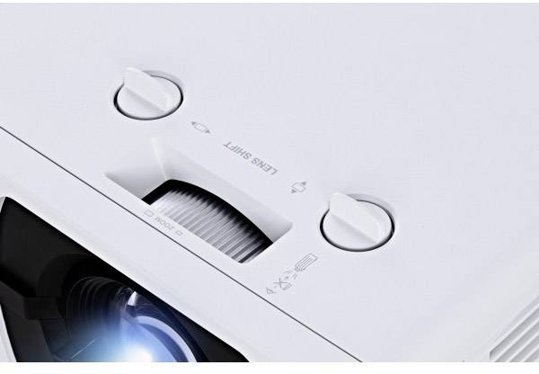 Close-up of a white projector lens with controls for 'Focus' and 'Lens Shift'.