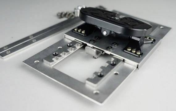 A metal cabinet fitting set with hinge and mounting rail on a grey background.