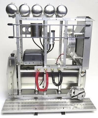 A complex mechanical device with multiple metal components, pipes, and cylinders. The main structure consists of a silver frame.