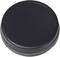 A black, round lid, most likely a lens cap, is lying flat on a surface.