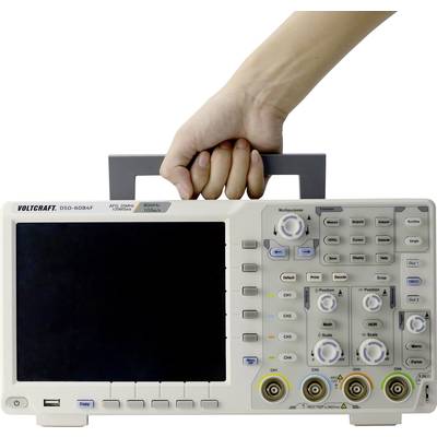 'Oscilloscope is carried by one hand, shows large display and control buttons. Brand name Voltcraft clearly visible.'