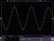 'Oscilloscope display with yellow sine-like signal. Horizontal axis shows time in nanoseconds, vertical axis shows voltage in millivolts.'