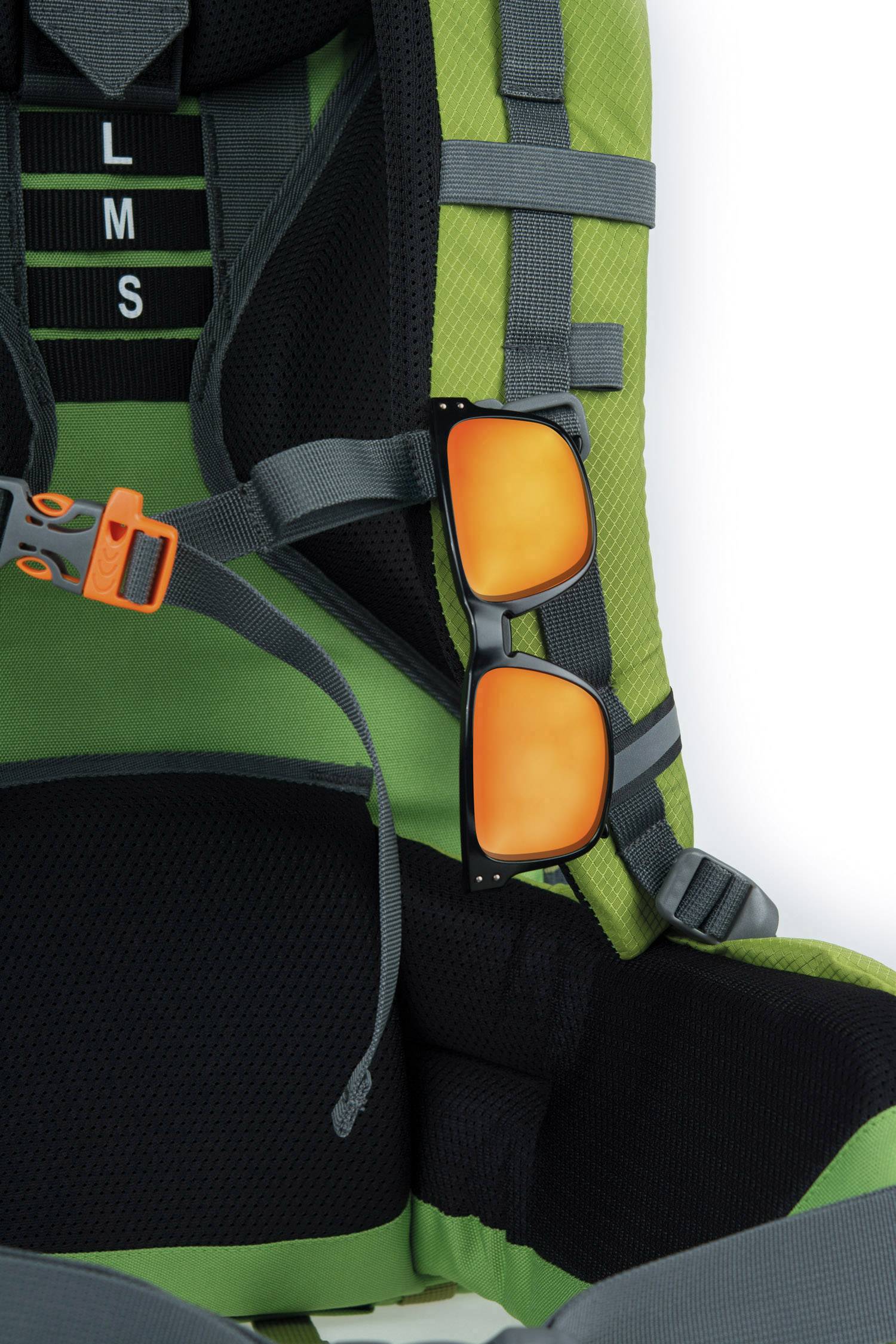 A green rucksack with black inner lining, with orange sunglasses attached to it.