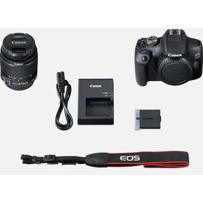 Digital camera with lens, charger, battery, cable, and camera strap. Complete kit for photography enthusiasts.