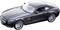Black toy car in 1:18 scale, showing a sporty design with striking headlights.