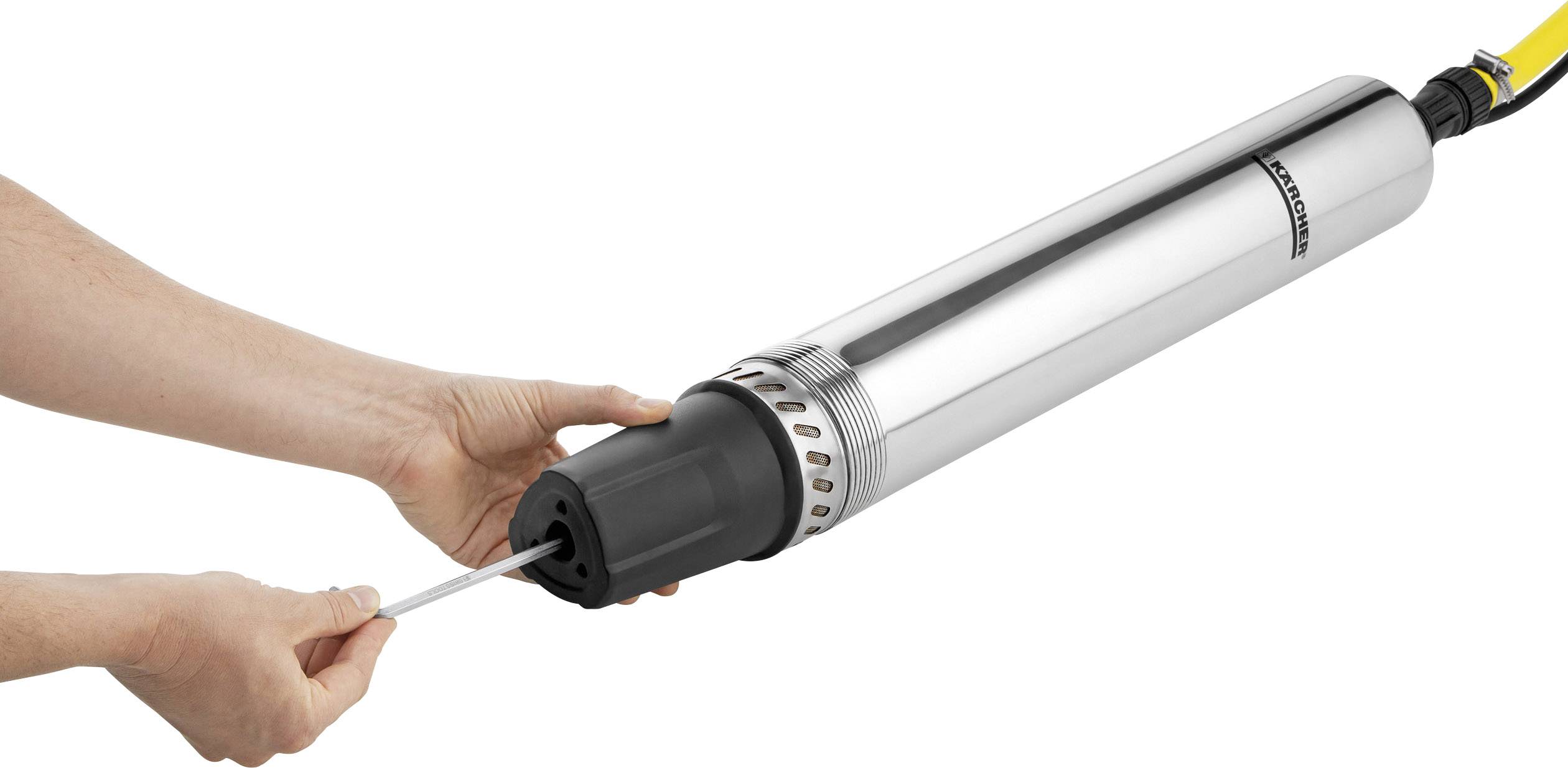 A person is holding a cylindrical, silver submersible pump while a second person attaches a cable to it.