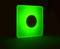 Green, luminous square with a black circle in the centre on a dark background.