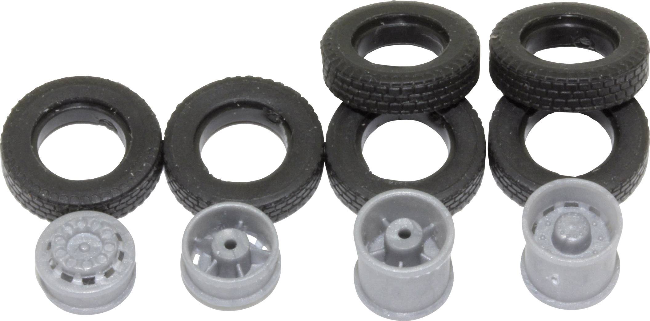 Six black tyres and six grey rims are lined up side by side, ready for mounting on toy cars.