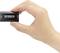 A hand is holding a small black adapter with the inscription 'Speaka Professional', with the ports 'Input' and 'Output' visible.