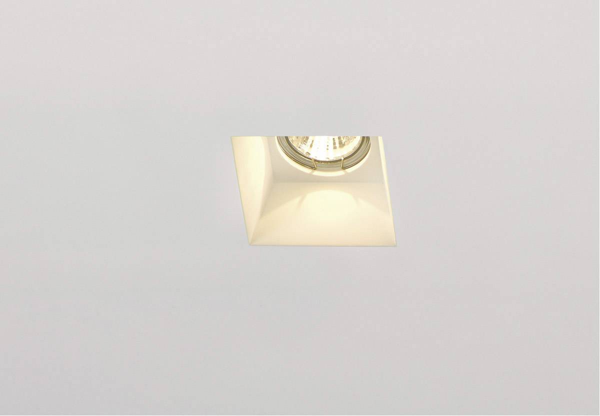 A single ceiling light in a modern, minimalist design, switched on and recessed in a suspended ceiling.