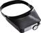Black head holder with integrated magnifying lens, suitable for hands-free magnification during precision work.