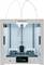 'Ultimaker 3D Printer' viewed from the front. Shows a modern, open print chamber with a digital display at the bottom for control and status indication.
