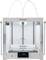 A modern 3D printer with transparent side panels and a digital display on the front, ready to print.