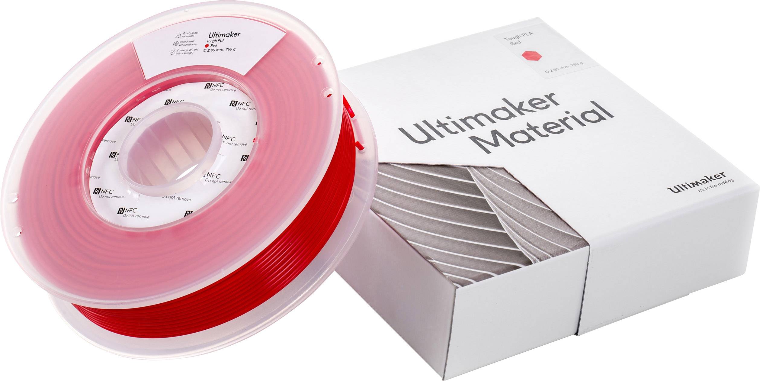 Red 3D printer filament reel next to a white packaging with the inscription 'Ultimaker Material'.