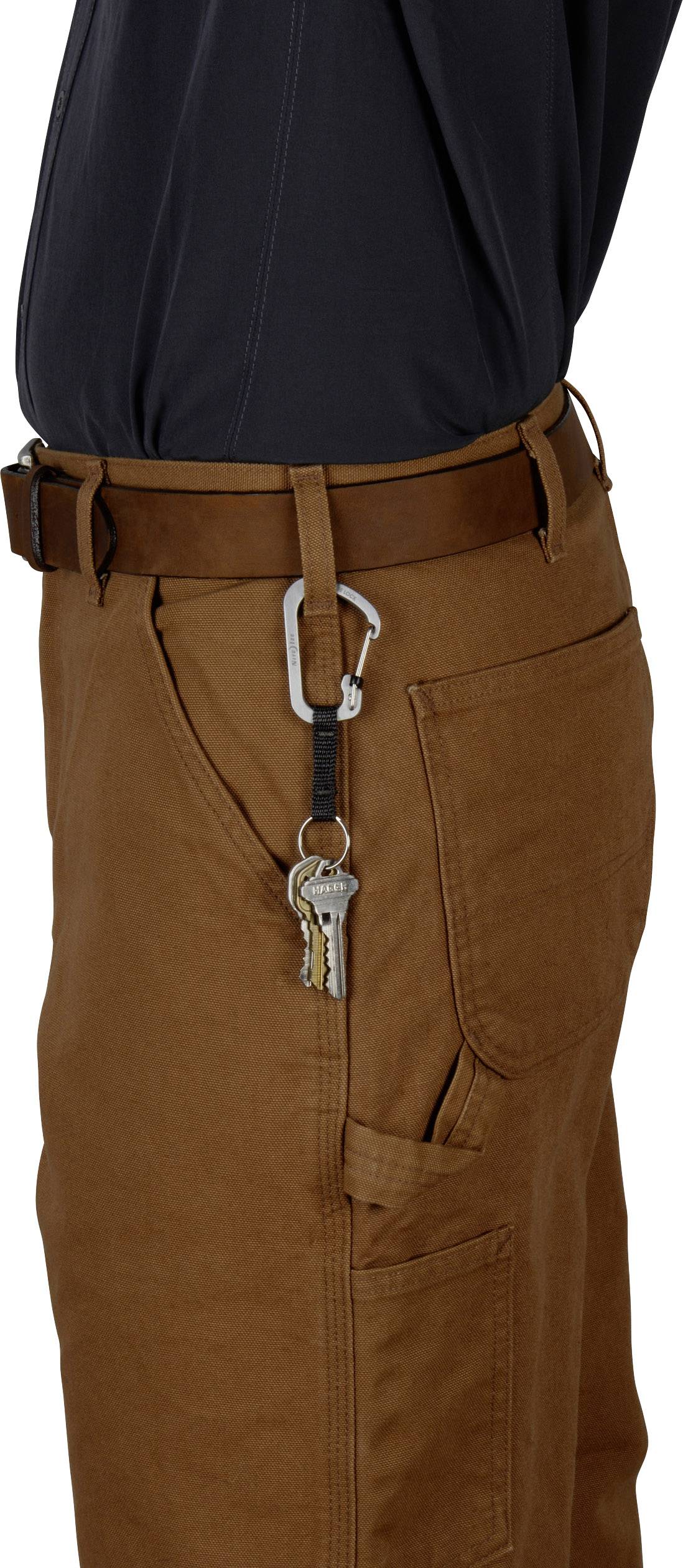 A person is wearing brown trousers with a key fob attached to a belt loop.