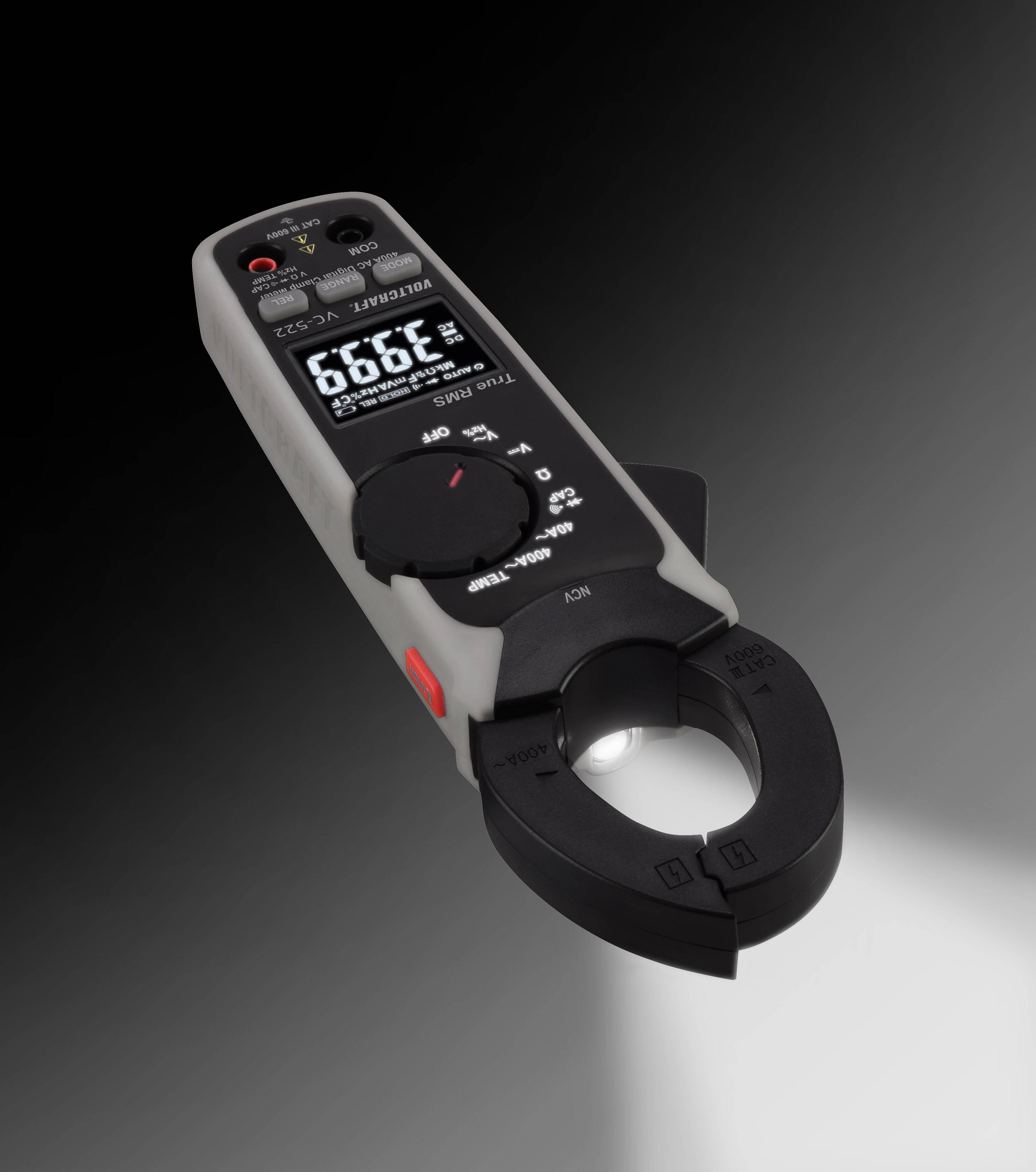 Digital clamp meter in a diagonal view with a readable display, illuminated clamp area and grey casing on a black background.