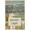 A sign reading 'Small Parts Storage' hangs from the ceiling of a metallic storeroom.